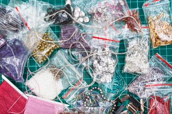 needlecraft background - top view of various items, beads, bugles, spangles, threads, gimps for embroidery close up