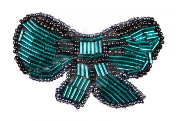 hand crafted bow tie shaped brooch from glass green bugles and black beads isolated on white background