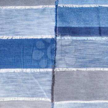 textile square background - patchwork from various denim flaps