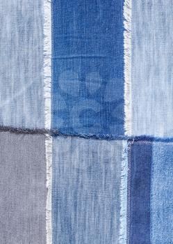 textile background - patchwork from various blue denim flaps close up