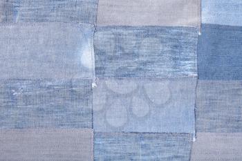 textile background - patchwork from old blue denim flaps