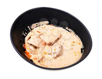 georgian cuisine - portion of Satsivi (spicy cold appetizer from chicken in walnut sauce) in black bowl isolated on white background