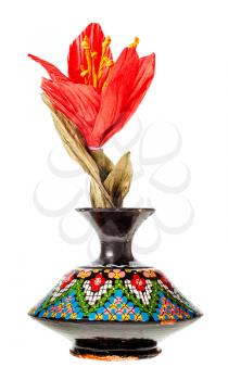 handmade artificial paper red flower in vintage arabian ceramic vase isolated on white background