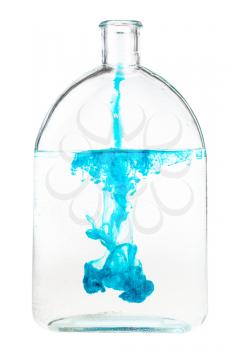 blue ink dissolves in water in glass flask isolated on white background
