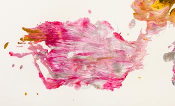 pink blot of acrylic paint on white paper close up