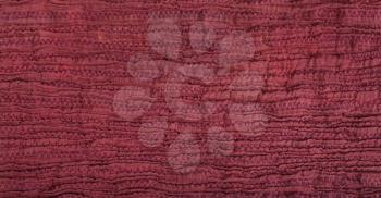surface of stitched crumpled red brown silk scarf