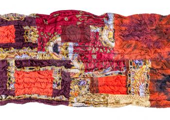 fragment of stitched red brown patchwork scarf isolated on white background