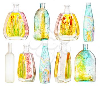 set of various hand painted glass bottles isolated on white background