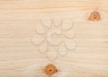 horizontal wooden background - unpainted pine plank with two knots close up
