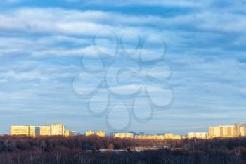 dark blue clouds over urban park in Moscow city at spring sunset