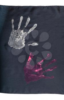 handpainted handprints on fragment of handcrafted black silk scarf isolated on white background