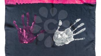fragment of handcrafted black silk scarf with handpainted handprints isolated on white background