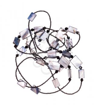 tangled handcrafted necklace from black glass beads and polished pieces of mother-of-pearl isolated on white background