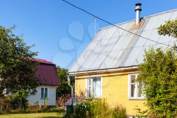wooden blockhouses in village in Russia on sunny summer day