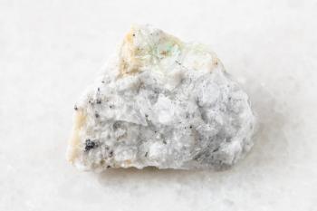 closeup of sample of natural mineral from geological collection - rough Baryte (Barite) ore on white marble background from Belorechensk deposit, Maykopsky District, Adygea, Russia