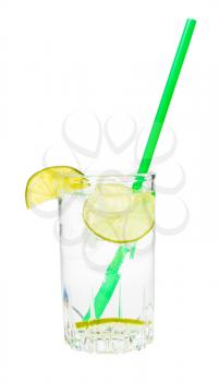 side view of glass with prepared gin and tonic cocktail on the rock with wedge and slices of lime and green plastic straw isolated on white background