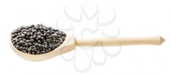 raw whole black urad beans in wooden spoon isolated on white background