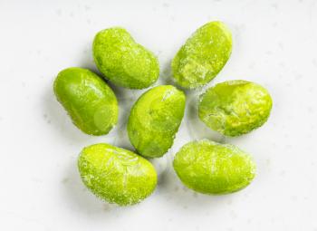 several frozen Edamame (unripe soybeans) close up on gray ceramic plate
