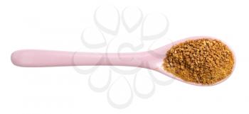 top view of granulated coconut blossom sugar in pink ceramic spoon isolated on white background