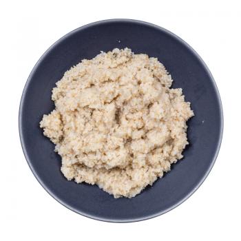 top view of porridge from crushed pot barley groats in gray bowl isolated on white background