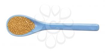 top view of granulated dried yeast in ceramic spoon isolated on white background
