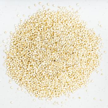 top view of pile of quinoa grains close up on gray ceramic plate