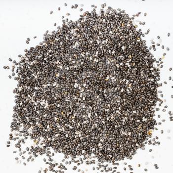 top view of pile of chia seeds close up on gray ceramic plate