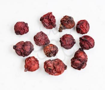few dried magnolia berries (Schisandra chinensis fruits) close up on gray ceramic plate