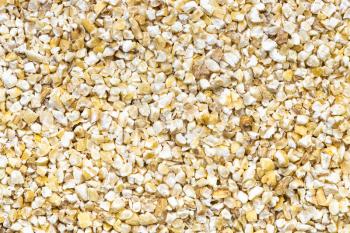 food background - uncooked crushed pot barley groats