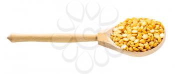 wooden spoon with dried split yellow peas isolated on white background