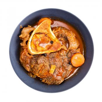 top view of portion of ossobuco (beef shin braised with vegetables, wine and broth) in gray bowl isolated on white background