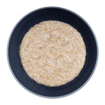 top view of cooked porridge from wheat groats (crushed partly hulled wheat grains) in gray bowl isolated on white background