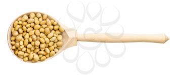 top view of wood spoon with raw dried soybeans isolated on white background