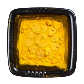 top view of curcuma (turmeric) powder in black bowl isolated on white background