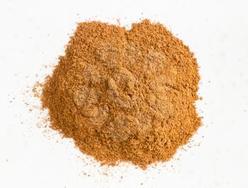 top view of pile of cinnamon powder close up on gray ceramic plate