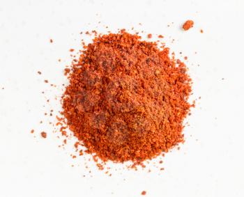 top view of pile of paprika powder close up on gray ceramic plate