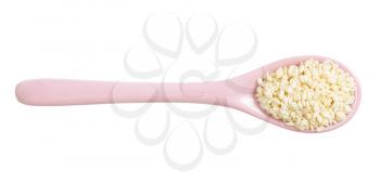 top view of ceramic spoon with raw white sesame seeds isolated on white background