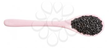 top view of ceramic spoon with raw black sesame seeds isolated on white background