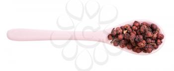 top view of ceramic spoon with dried schisandra fruits isolated on white background