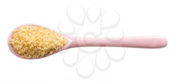 top view of demerara brown cane sugar in pink ceramic spoon isolated on white background