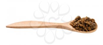 dark muscovado cane sugar in wooden spoon isolated on white background