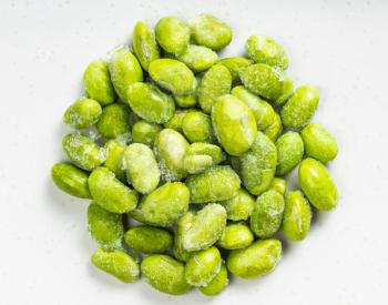 top view of pile of frozen Edamame (unripe soybeans) close up on gray ceramic plate