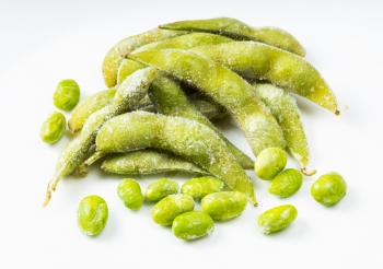 frozen pods and seeds of Edamame (unripe soybeans) on gray ceramic plate