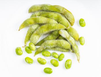 top view of frozen pods and seeds of Edamame (unripe soybeans) on gray ceramic plate