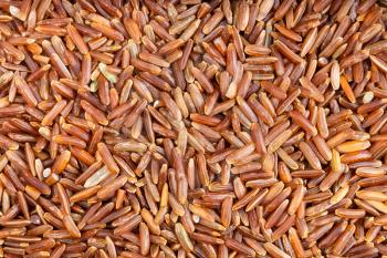 food background - many raw red rice grains close up