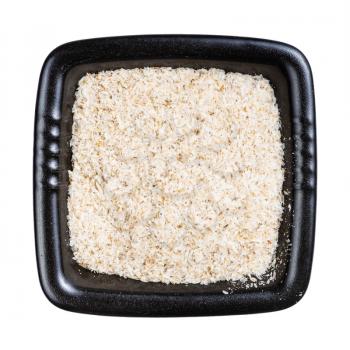 top view of psyllium husk in black bowl isolated on white background