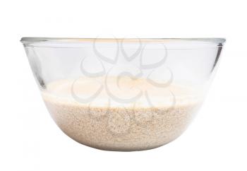 side view of amaranth porridge boiled with coconut milk in glass bowl isolated on white background