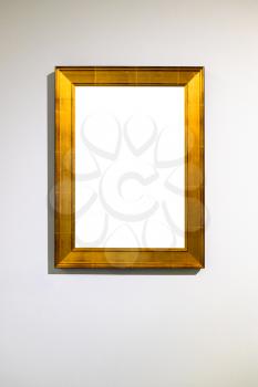 vertical wide flat golden picture frame with cutout canvas on vertical wall