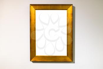 vertical wide flat golden picture frame with cutout canvas on horizontal wall