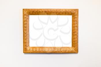 old carved wide wood picture frame with cutout canvas on white wall
